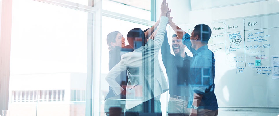 Team in the meeting room celebrating the success 