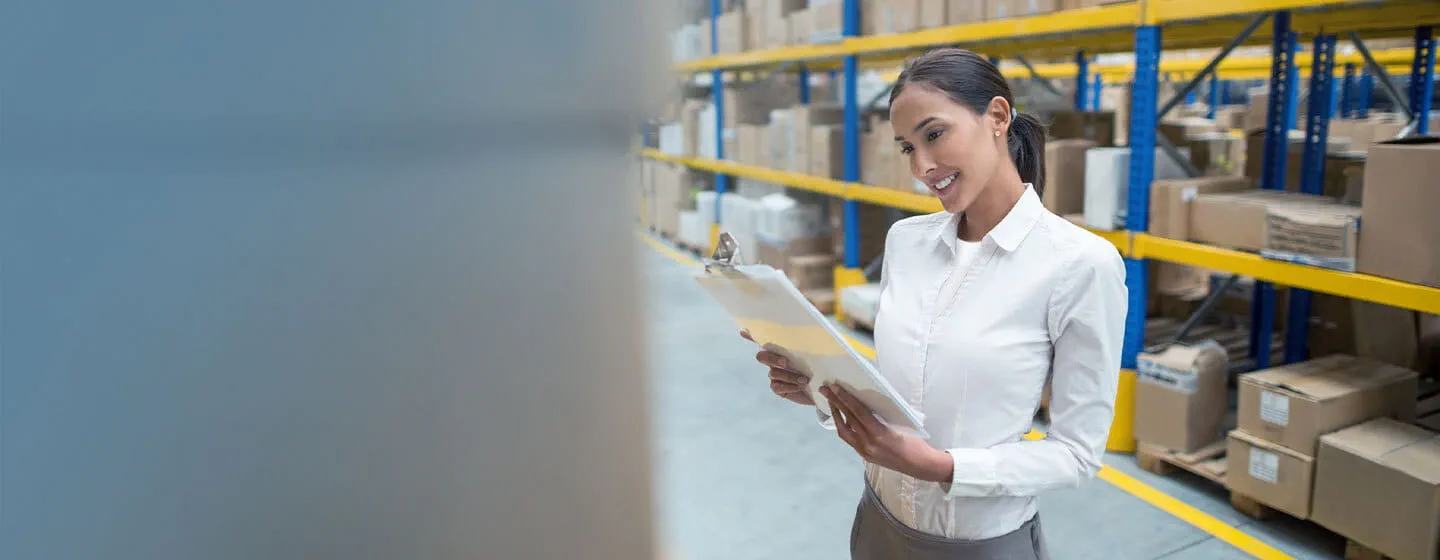 Warehouse management employee checking inventory