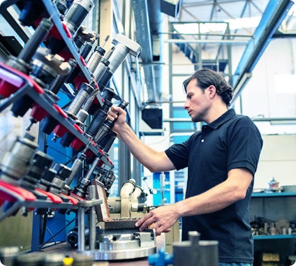 Employee of a mechanical workshop choosing tools