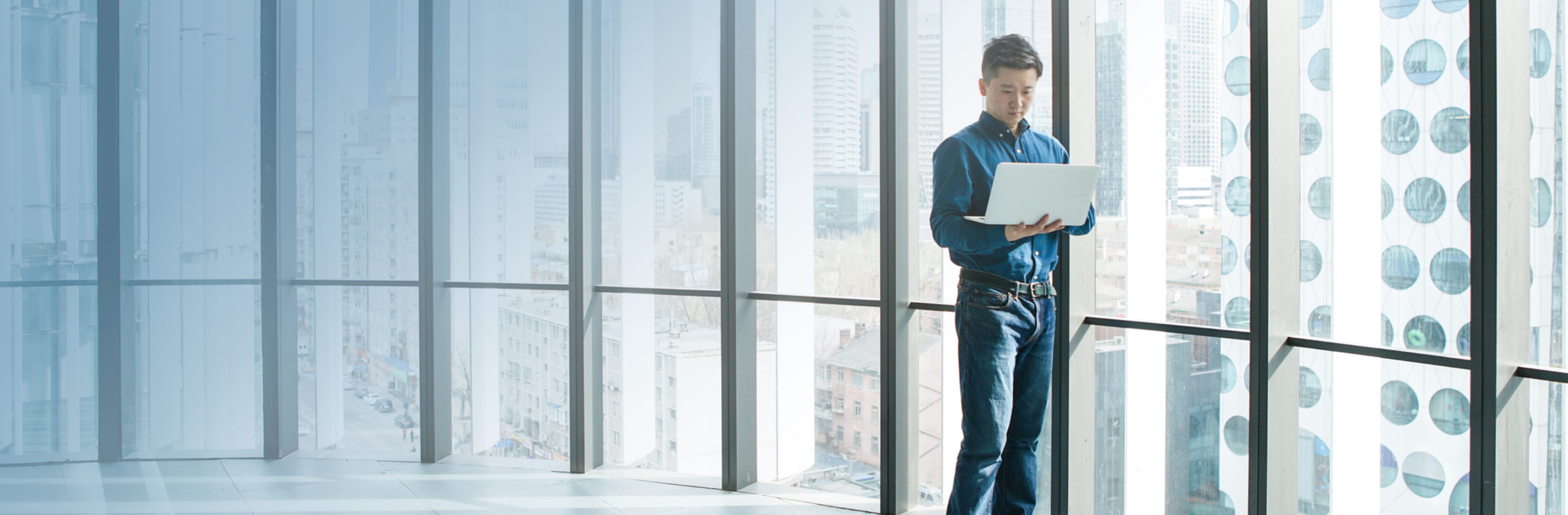 man working on the laptop while standing